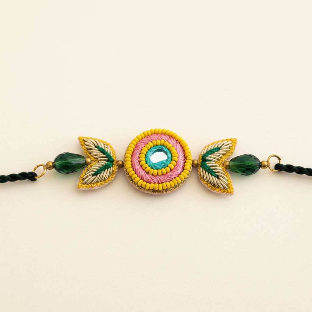 Handcrafted Circle Motif Rakhi – Green Thread with Leaf Accents