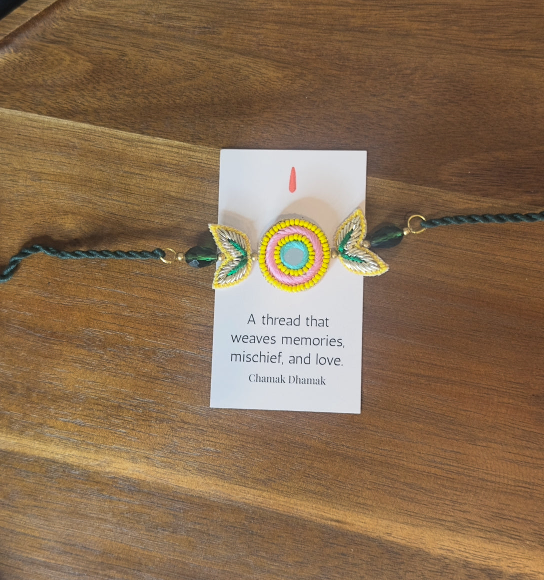 Handcrafted Circle Motif Rakhi β Green Thread with Leaf Accents
