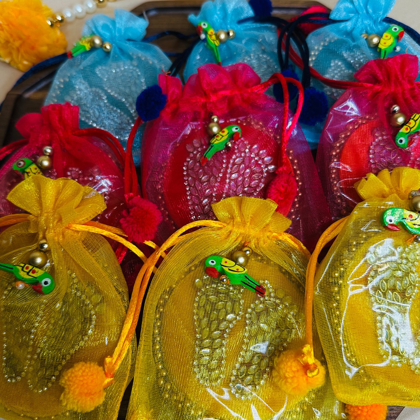 Lakshmi Paduka Return Gifts – Mixed Color Potli Bags with Parrot Embellishments (Set of 1)