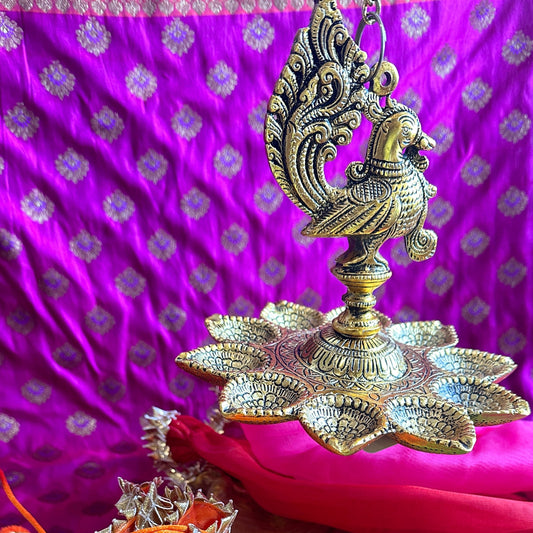 Red & Gold Potli – Packed with Metal Gold Oxide Mor Diya Hanging | Ready to Gift