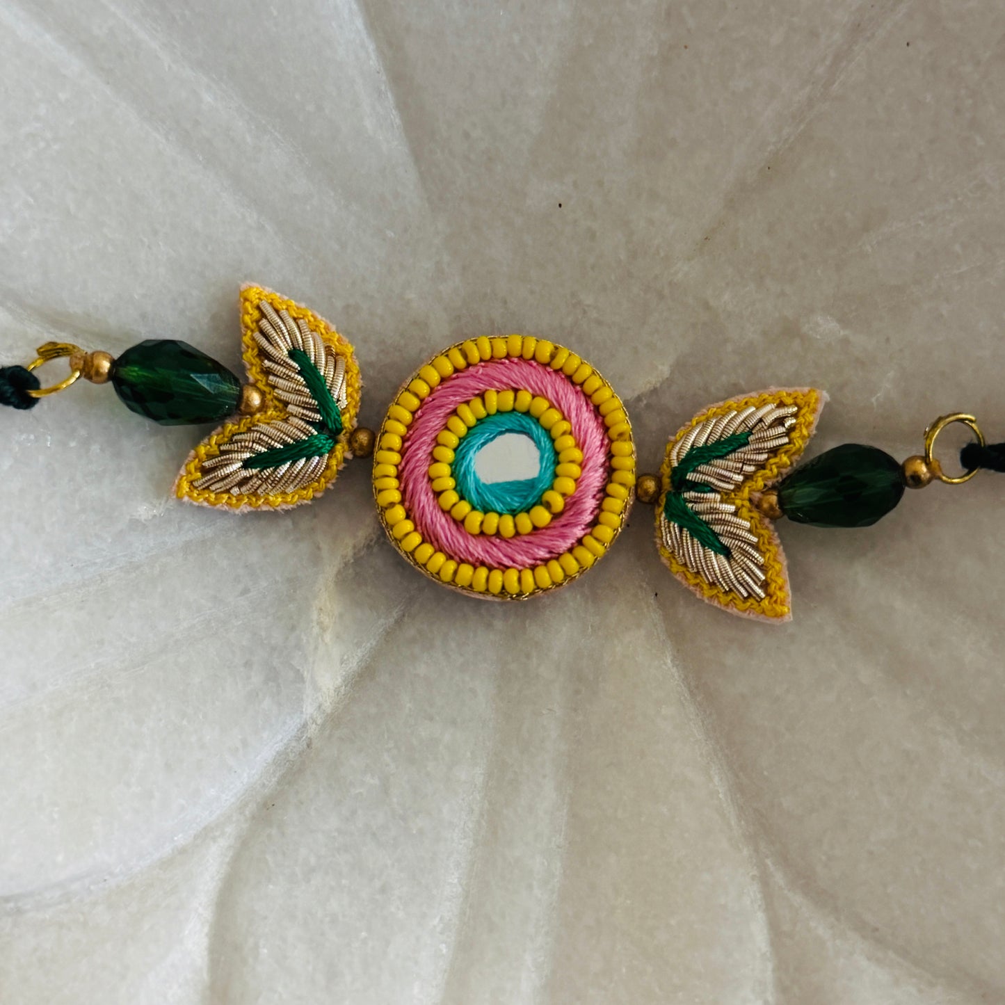 Handcrafted Circle Motif Rakhi – Green Thread with Leaf Accents
